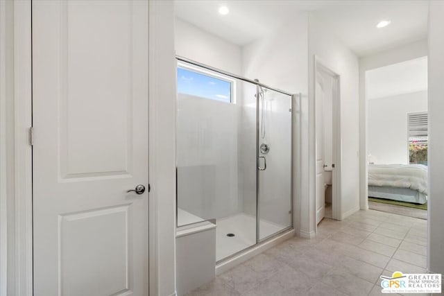 bathroom featuring tile patterned floors and a shower with door