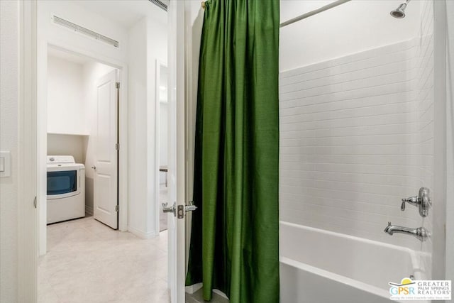 bathroom featuring shower / bath combo with shower curtain and washer / dryer