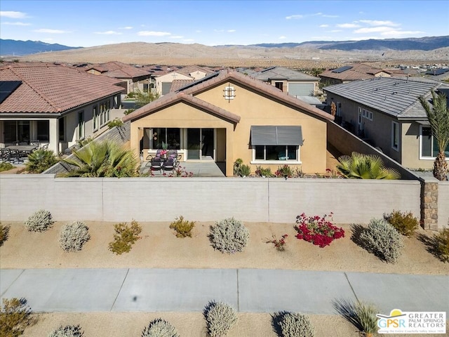 view of front of home featuring a mountain view and a patio