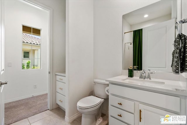 bathroom featuring tile patterned floors, plenty of natural light, toilet, and vanity