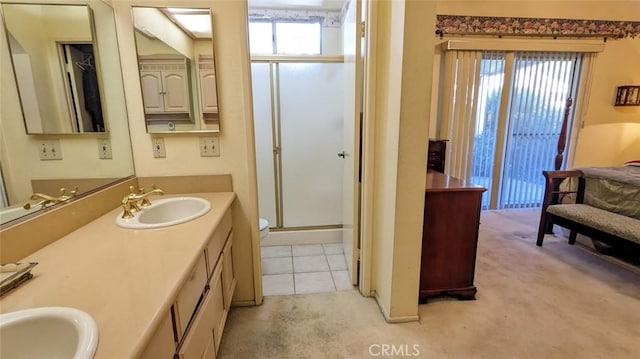 bathroom featuring tile patterned flooring, vanity, an enclosed shower, and toilet