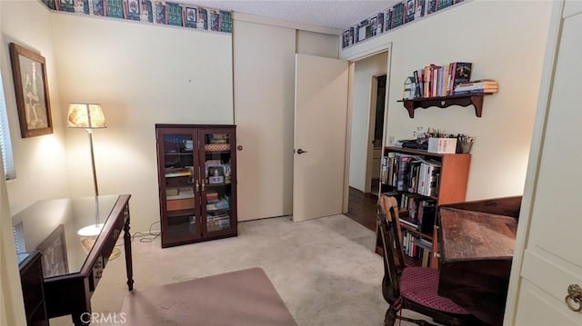 home office featuring carpet flooring and a textured ceiling