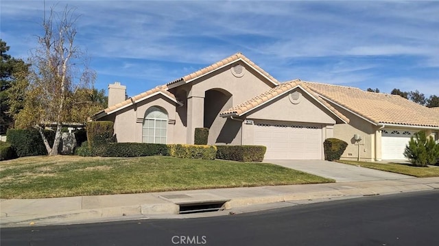 view of front of property featuring a garage and a front yard