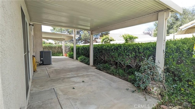 view of patio featuring central AC and fence