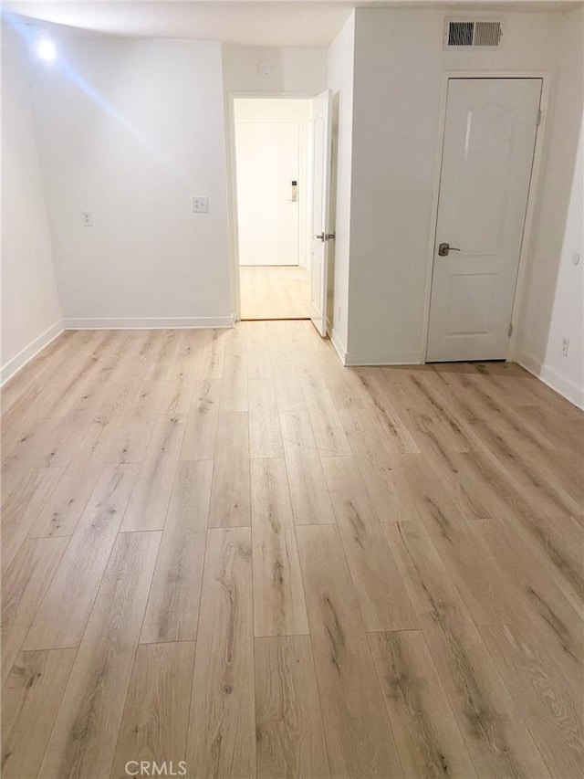 empty room with light hardwood / wood-style floors