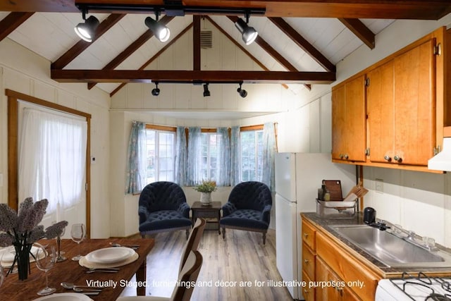 kitchen with white refrigerator, sink, hardwood / wood-style flooring, range hood, and beam ceiling