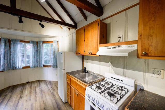 kitchen with hardwood / wood-style flooring, vaulted ceiling with beams, white appliances, and sink