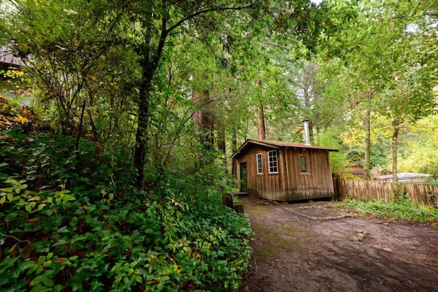 view of side of home featuring an outdoor structure