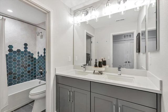 full bathroom with tile patterned floors, vanity, toilet, and shower / bath combo with shower curtain