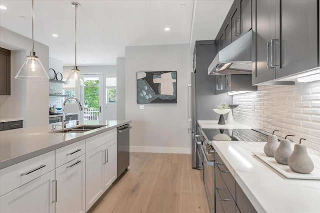 kitchen with dishwasher, sink, hanging light fixtures, ventilation hood, and white cabinets