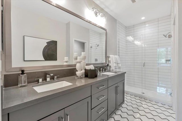 bathroom with tile patterned flooring, vanity, and a shower with door