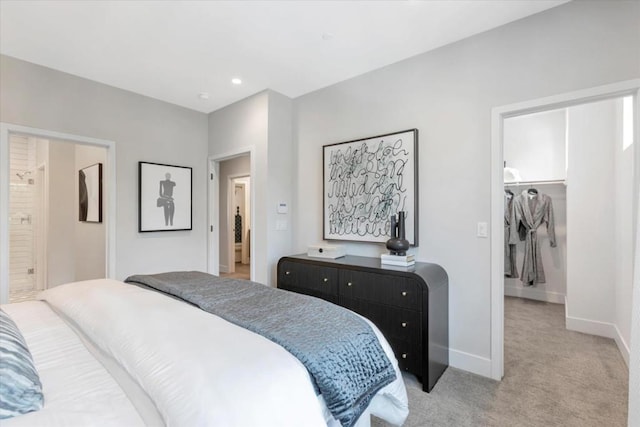 carpeted bedroom featuring a walk in closet and a closet