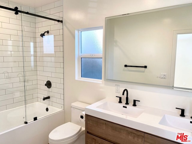 full bathroom featuring vanity, toilet, and combined bath / shower with glass door