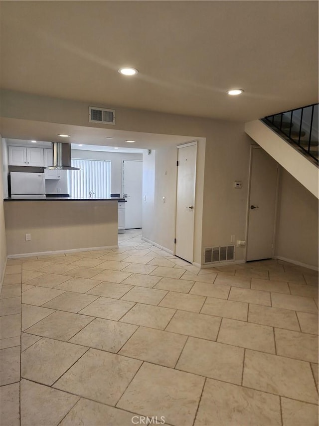 spare room featuring recessed lighting, visible vents, and baseboards