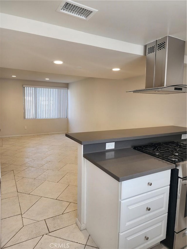 kitchen with white cabinetry, light tile patterned floors, island range hood, and stainless steel gas range oven