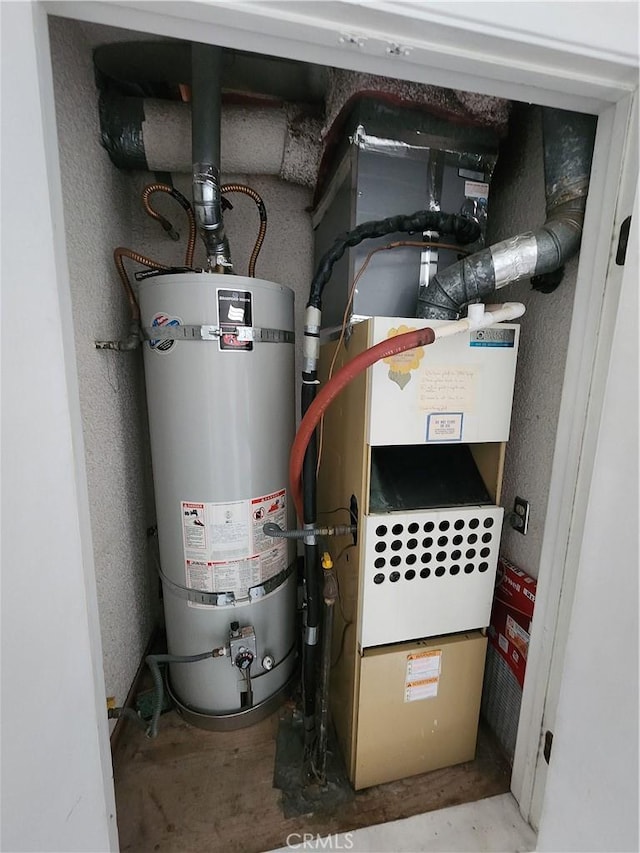 utility room with strapped water heater