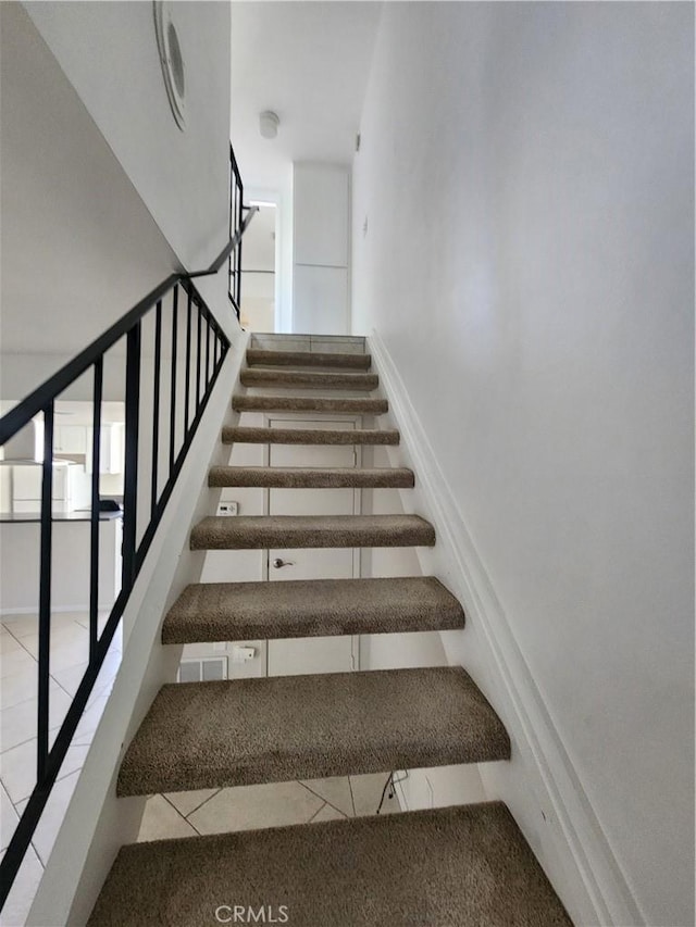 stairway featuring tile patterned floors