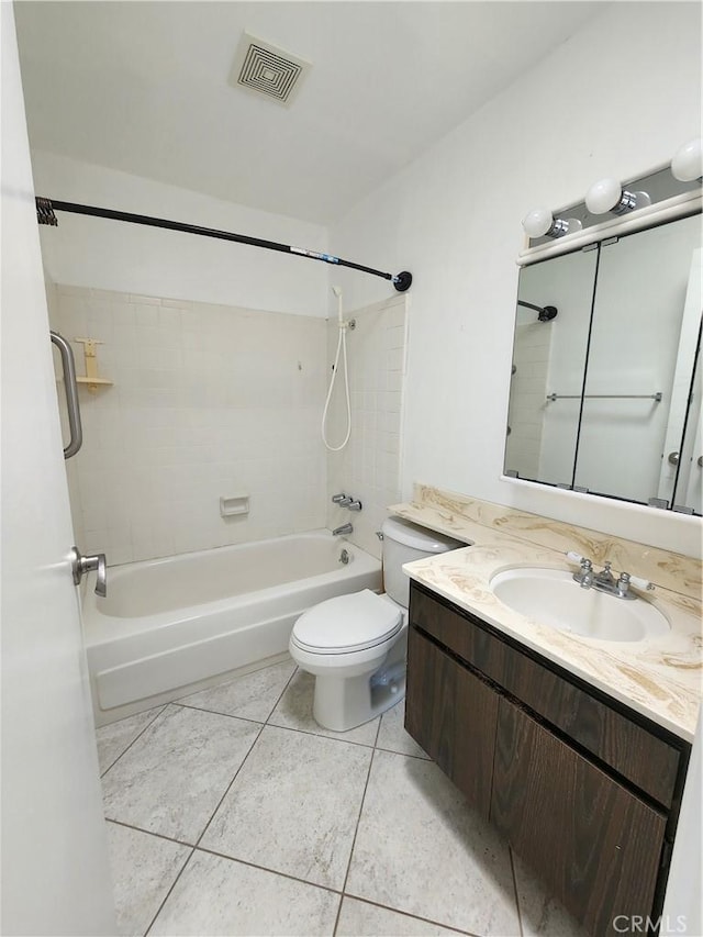 full bathroom with tiled shower / bath, tile patterned floors, toilet, and vanity