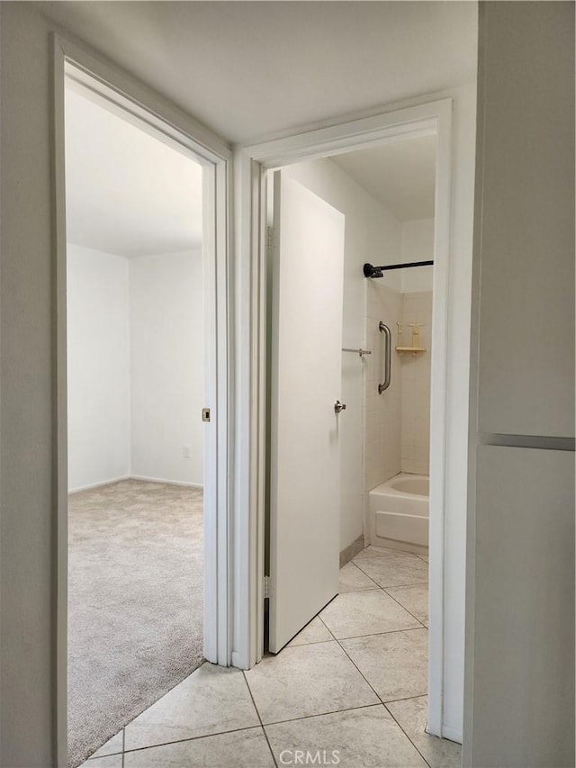 bathroom featuring tile patterned flooring and shower / bath combination