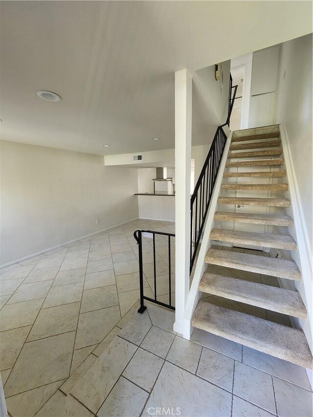 stairs featuring visible vents and baseboards