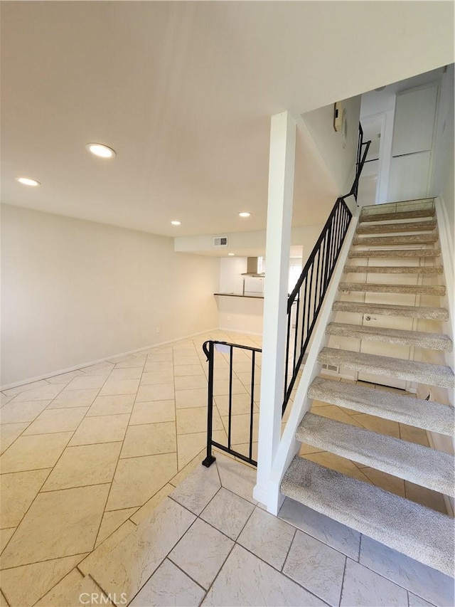 stairway with recessed lighting and visible vents