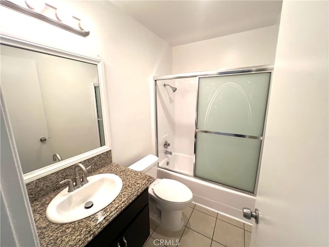 full bathroom featuring tile patterned flooring, vanity, toilet, and enclosed tub / shower combo