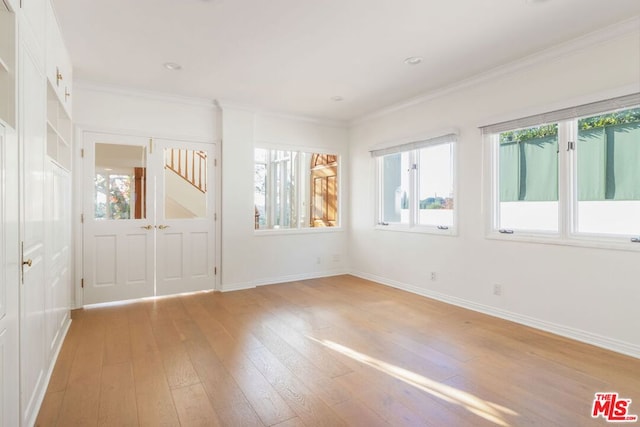 unfurnished room with light hardwood / wood-style flooring and ornamental molding