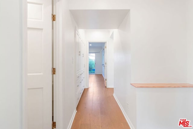 hall with light hardwood / wood-style floors