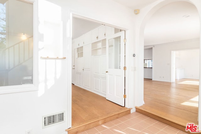 corridor with light tile patterned floors