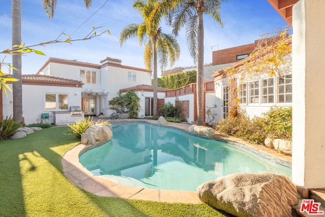 view of pool featuring grilling area