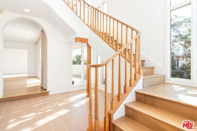 stairs with tile patterned flooring and a wealth of natural light