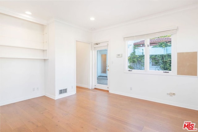 spare room with light hardwood / wood-style flooring and ornamental molding