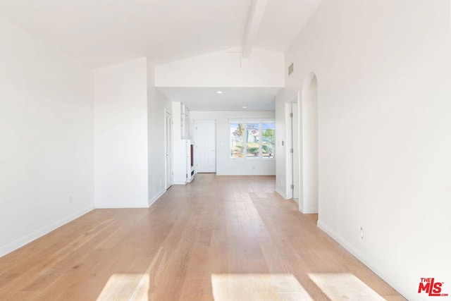 corridor featuring light hardwood / wood-style flooring and vaulted ceiling with beams