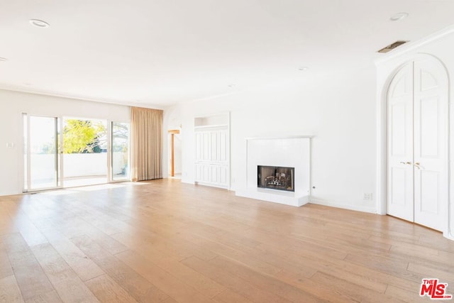 unfurnished living room with light hardwood / wood-style flooring