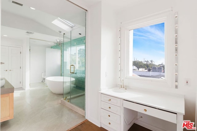 bathroom featuring vanity, vaulted ceiling, and separate shower and tub