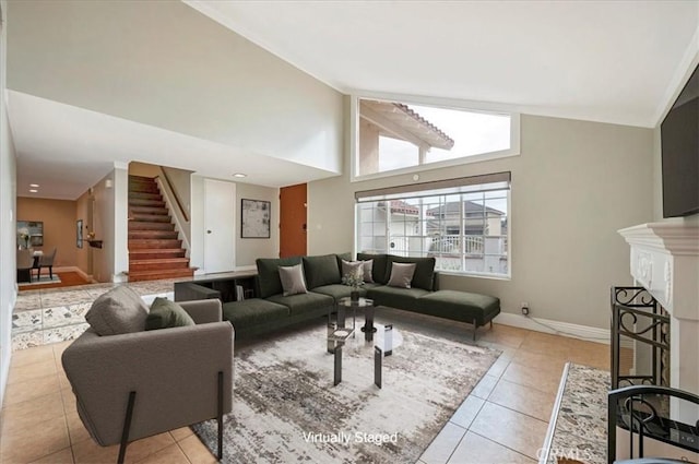 living room featuring light tile patterned floors and high vaulted ceiling