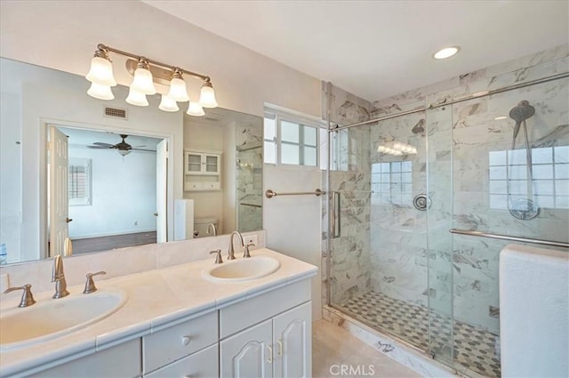 bathroom with walk in shower, vanity, toilet, and ceiling fan