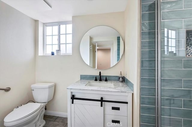 bathroom featuring toilet, vanity, and tile patterned floors