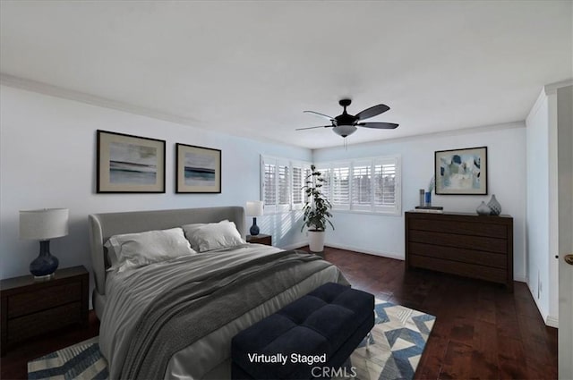 bedroom with ornamental molding, ceiling fan, and dark wood-type flooring