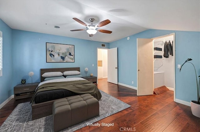 bedroom with vaulted ceiling, ceiling fan, a closet, and dark hardwood / wood-style floors