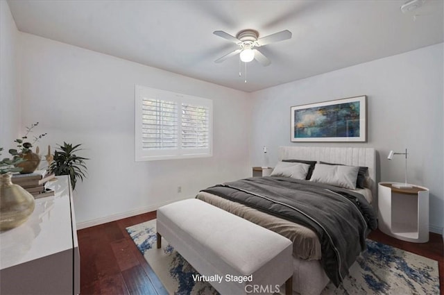 bedroom with ceiling fan and dark hardwood / wood-style flooring