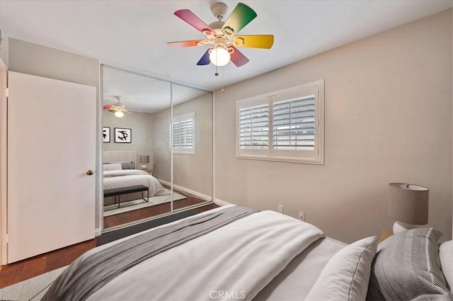 bedroom featuring hardwood / wood-style flooring, ceiling fan, and a closet