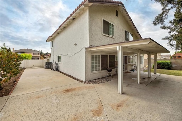 exterior space with cooling unit and a patio area