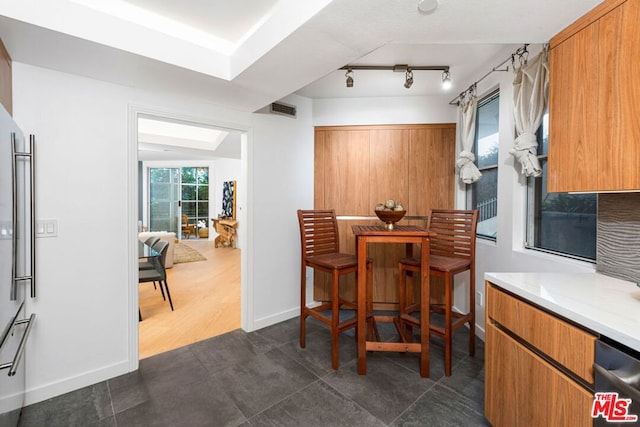 tiled dining space featuring lofted ceiling