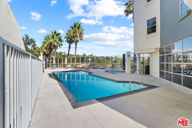 view of swimming pool with a patio area