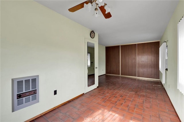 32222 Richard St, Lucerne Valley, CA 92356 - unfurnished room featuring heating unit, tile patterned floors, and a ceiling fan