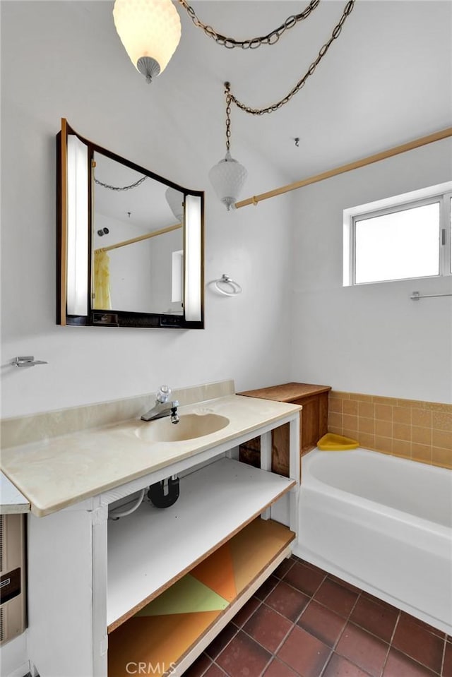 bathroom featuring tile patterned floors, vanity, and a bath