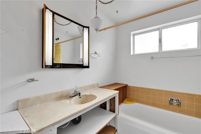 bathroom featuring vanity and a tub to relax in