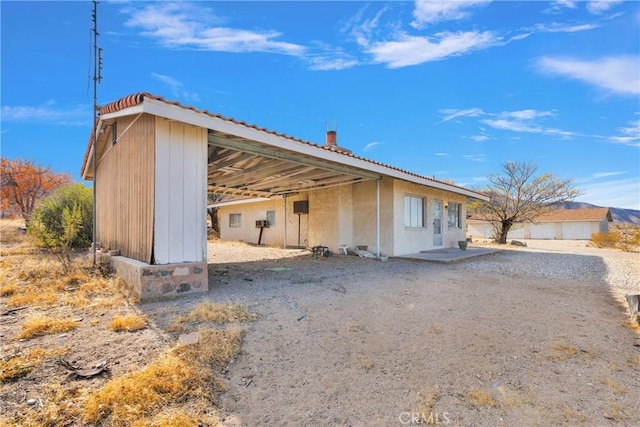 32222 Richard St, Lucerne Valley, CA 92356 - exterior space featuring an outdoor structure, a tiled roof, and stucco siding