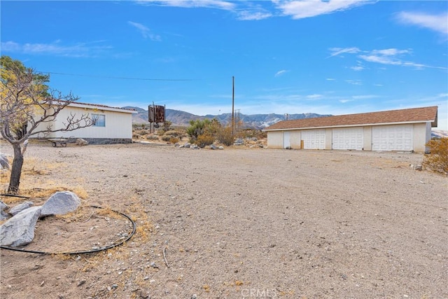 32222 Richard St, Lucerne Valley, CA 92356 - view of yard with a detached garage, an outdoor structure, and a mountain view